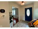 Welcoming foyer features a blue front door and access to a living space with hardwood flooring at 4625 Woodcrest Dr, Columbus, IN 47203