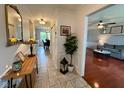 Inviting hallway featuring tile flooring, a decorative mirror, and transitions into the living room and dining area at 4625 Woodcrest Dr, Columbus, IN 47203