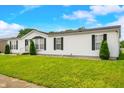 Charming single-story home with a well-manicured lawn and classic white siding at 4640 Autumn Ridge Dr, Columbus, IN 47203