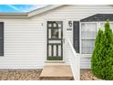 Close-up of the front door with decorative glass and white trim at 4640 Autumn Ridge Dr, Columbus, IN 47203