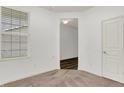 Neutral carpeted bedroom features a window and white door at 5125 Lilium Dr, Plainfield, IN 46168