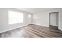 Well-lit living room features sleek flooring, white trim, and ample space for comfortable living at 564 S Bosart Ave, Indianapolis, IN 46203