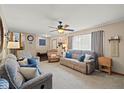 Cozy living room with plush seating, a ceiling fan, and plenty of natural light at 580 Northgate Dr, Greenwood, IN 46143