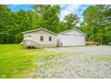 Charming home featuring a white exterior with a large detached garage and a gravel driveway at 5858 N West Shore Dr, Morgantown, IN 46160