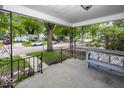 Inviting covered front porch with seating, decorative iron railings, and a view of the neighborhood at 6005 Winthrop Ave, Indianapolis, IN 46220