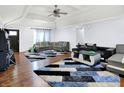 Spacious living room with vaulted ceiling, hardwood floors, modern sofas, stylish rug, and ceiling fan at 602 Pioneer Dr, Indianapolis, IN 46217
