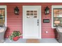 Close-up of a charming front porch with decorative lighting, potted plants, and stylish front door at 625 E 57Th St, Indianapolis, IN 46220