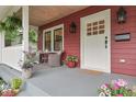 Inviting front porch featuring decorative plants, comfortable seating, and a charming exterior design at 625 E 57Th St, Indianapolis, IN 46220