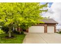 Inviting brick home with a spacious two-car garage and a well-maintained driveway at 6307 Keeneland Ct, Indianapolis, IN 46278