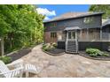 Inviting backyard patio and a deck with stairs, surrounded by mature trees and lush landscaping at 6350 Red Oak Dr, Avon, IN 46123