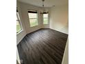 Bright dining room with updated flooring and chandelier at 6744 Redan Dr, Indianapolis, IN 46254