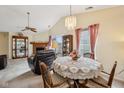 Cozy dining area featuring vaulted ceilings, a decorative chandelier, and a charming lace tablecloth at 69 Stoneybrook Dr, Greenwood, IN 46142