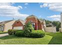 Beautiful brick home with attached garage, mature landscaping, and lovely yard at 69 Stoneybrook Dr, Greenwood, IN 46142