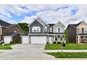 Charming two-story home with a well-manicured lawn, a three car garage and beautiful curb appeal at 7147 Buckley Branch Dr, Indianapolis, IN 46259