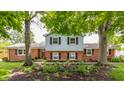 Inviting home showcasing brick and siding exterior, enhanced by well-maintained landscaping and mature trees at 7935 N County Road 650 E, Brownsburg, IN 46112