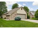 Beautiful brick home with a two-car garage, well-maintained lawn, and mature landscaping at 842 Cheltenham Way, Avon, IN 46123