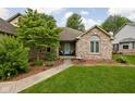 Inviting brick home featuring a charming front porch and a well-manicured lawn at 842 Cheltenham Way, Avon, IN 46123