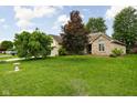 Expansive front yard with mature trees offering shade and curb appeal to the beautiful brick home at 842 Cheltenham Way, Avon, IN 46123