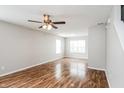 Bright and airy living area with hardwood floors and a modern ceiling fan at 9220 Crossing Dr, Fishers, IN 46037