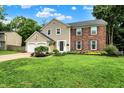 Beautifully maintained two-story home with a lush green lawn, two-car garage, and inviting curb appeal at 9302 Budd Run Dr, Indianapolis, IN 46250
