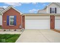 Two-car garage with brick accents and vinyl siding, with a well-maintained driveway and lawn at 9682 Angelica Dr, Noblesville, IN 46060