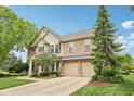 Charming brick home boasts a professionally landscaped yard and spacious three car garage at 9833 Parkshore Dr, Fishers, IN 46038