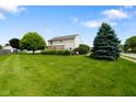 Expansive backyard featuring a lush lawn, mature trees, and a wooden deck perfect for outdoor entertaining at 101 Meadowview Dr, Mooresville, IN 46158