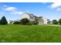 Well-maintained home with a large front yard, mature trees, and a two-car garage, nestled in a friendly neighborhood at 101 Meadowview Dr, Mooresville, IN 46158