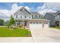 Charming two-story home featuring stone accents, a welcoming porch, and a three-car attached garage at 1026 Woodglen Dr, Westfield, IN 46074