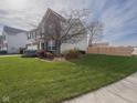 Well-maintained home with green lawn, mature tree, and a combination brick and siding exterior at 10443 Ringtail Pl, Fishers, IN 46038