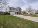 Attractive two-story home with a two-car garage, a well-kept lawn, and a charming front porch at 10443 Ringtail Pl, Fishers, IN 46038