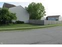 A fenced side yard with well kept grass, providing privacy and space for outdoor activities at 10443 Ringtail Pl, Fishers, IN 46038