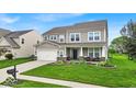 Charming two-story home with manicured lawn and inviting front porch at 10515 Sugar Ridge Way, Indianapolis, IN 46239