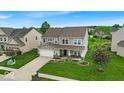 Beautiful two-story house featuring manicured lawn and lovely landscaping at 10515 Sugar Ridge Way, Indianapolis, IN 46239