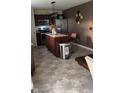Open kitchen featuring stainless steel appliances, island with bar stools, and modern fixtures at 10835 Spirit Dr, Ingalls, IN 46048