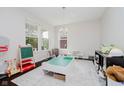 Bright playroom featuring large windows, a play table, and ample space for activities at 10962 Stoneleigh Dr, Noblesville, IN 46060