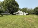 Quaint one-story home with a spacious lawn and detached garage at 11026 N Kitchen Rd, Mooresville, IN 46158