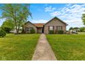 Charming single-story home with well-manicured lawn and inviting walkway at 1202 Orphant Annie, Greenfield, IN 46140
