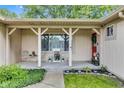 Inviting covered porch with a 'Welcome' sign, decor, and charming accents, enhancing the home's curb appeal at 12121 East 21St St, Indianapolis, IN 46229
