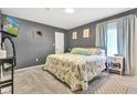 Calm main bedroom with gray walls, a patterned quilt, plush carpet, and a TV for added comfort at 12121 East 21St St, Indianapolis, IN 46229