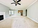 Spacious living room featuring neutral carpet, a cozy fireplace, and an open view to the kitchen at 1280 Shadow Ridge Rd, Indianapolis, IN 46280
