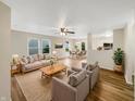 Bright living room featuring stylish furnishings, hardwood floors, and seamless flow into dining area at 13094 N Etna Green Dr, Camby, IN 46113