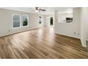 Open-concept living area with hardwood floors, bright windows, and a seamless transition to the kitchen at 13094 N Etna Green Dr, Camby, IN 46113