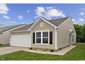 Classic exterior with garage, window, and clean landscaping at 1313 Kenwood Dr, Greenwood, IN 46143