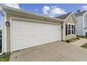 Home exterior displaying a garage and neatly kept landscaping at 1313 Kenwood Dr, Greenwood, IN 46143