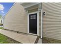 Side entrance featuring a black door with window panes and siding at 1313 Kenwood Dr, Greenwood, IN 46143