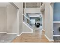 Spacious foyer with hardwood floors, a staircase, and an open view to the living room at 13766 Heatherfield Dr, Fishers, IN 46038