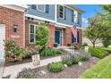 Inviting front porch with colorful flower beds and a sidewalk leading to the front door at 13766 Heatherfield Dr, Fishers, IN 46038