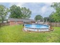 Large backyard with an above ground pool and a deck, perfect for outdoor entertaining at 1514 Bittersweet Dr, Greenfield, IN 46140