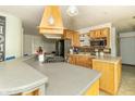Well-equipped kitchen featuring wooden cabinets, an island with seating, and modern appliances at 1514 Bittersweet Dr, Greenfield, IN 46140